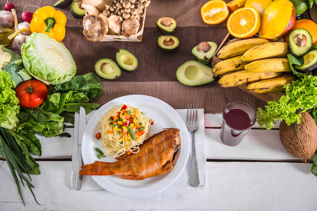 A selection of heart healthy foods, including salmon, leafy greens, and nuts, laid out on a table.